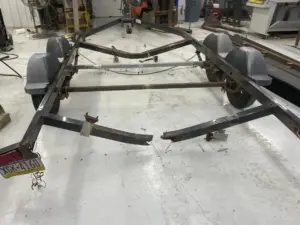 Rusted boat trailer frame with rear rails broken off, brought to Iron Mann Industries in Flint, MI for repair.