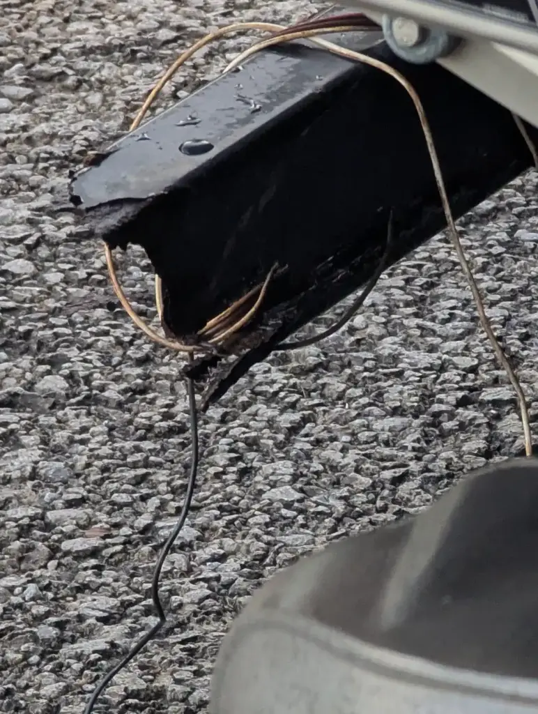Close-up of rusted and broken rear frame tube on a boat trailer before repair at Iron Mann Industries.