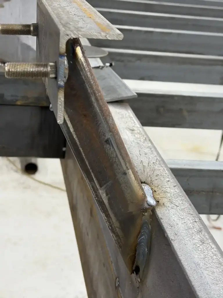 Custom bracket welded onto trailer frame at Iron Mann Industries