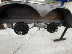 Trailer axle hub assembly and brake drums during build at IronMann Industries Flint MI