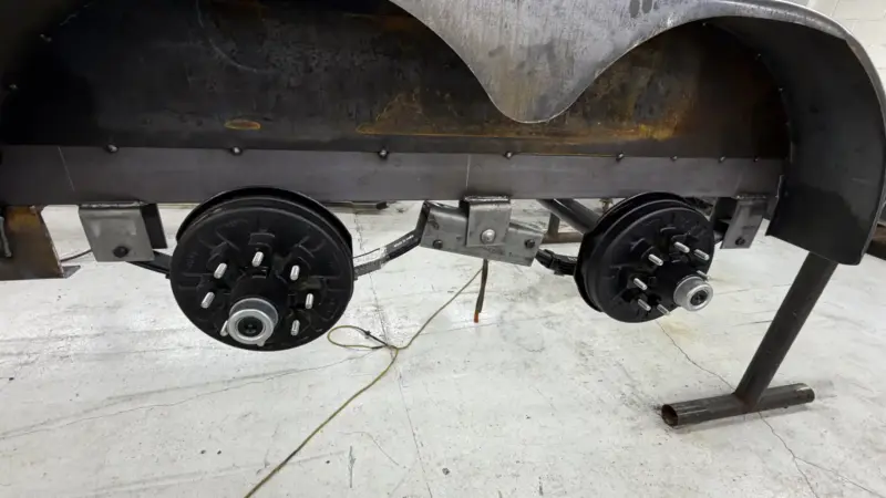 Trailer axle hub assembly and brake drums during build at IronMann Industries Flint MI