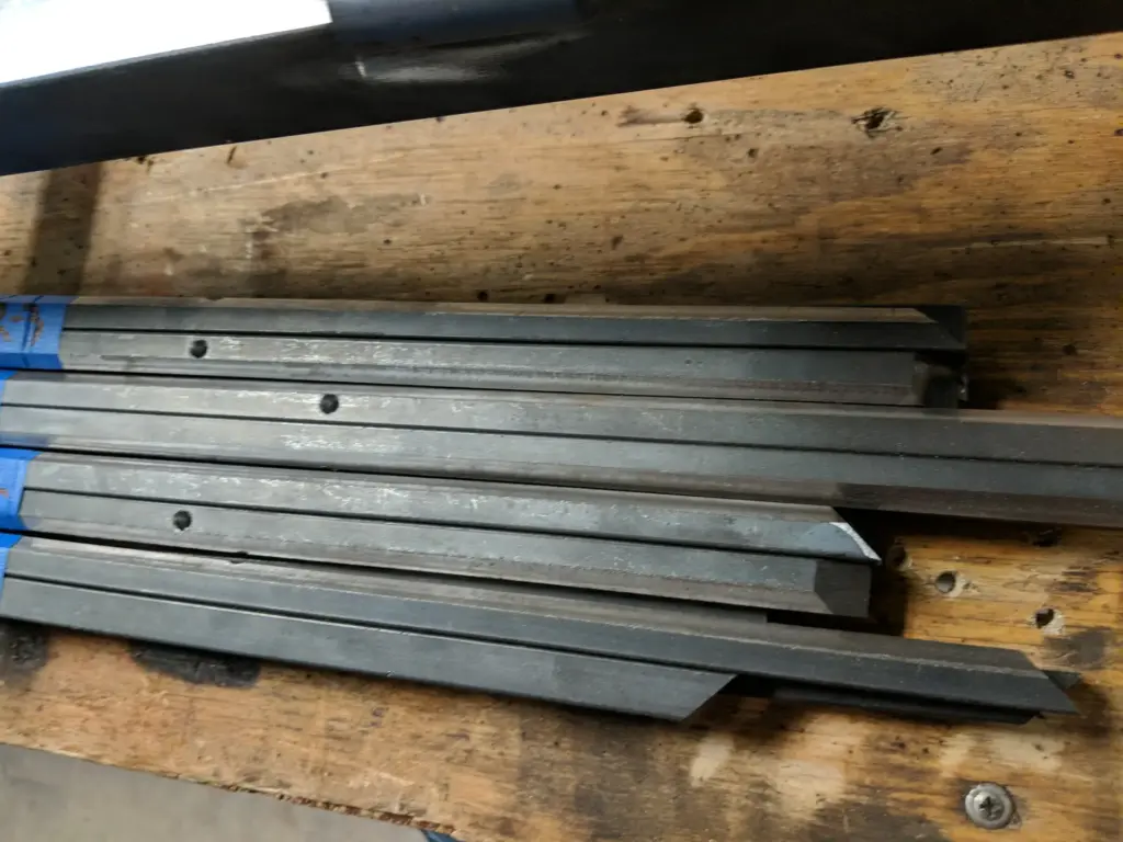 Steel bar and tube stock cut to length for a custom steel door build at IronMann Industries in Flint, MI