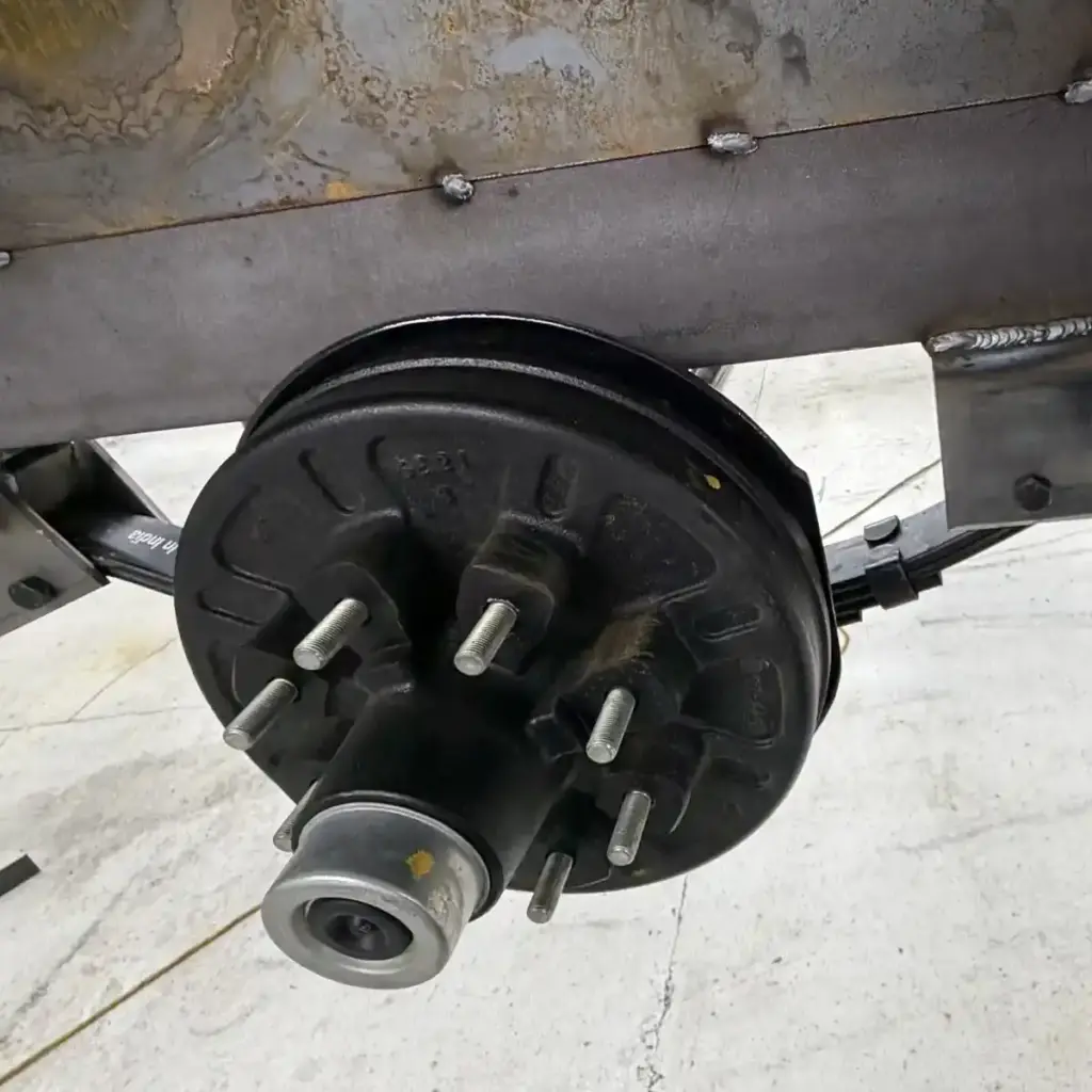 Recessed red LED tail light mounted in the rear panel of a black utility trailer, illustrating Michigan trailer lighting requirements
Placement